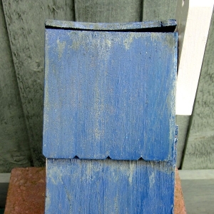 The roof of my mosaic bird box that I painted in a shade of blue to match the tiles, then...