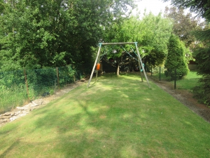 Behind the trampoline looking down to the bottom of the garden