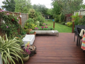 Small potted area on the decking looking down the garden